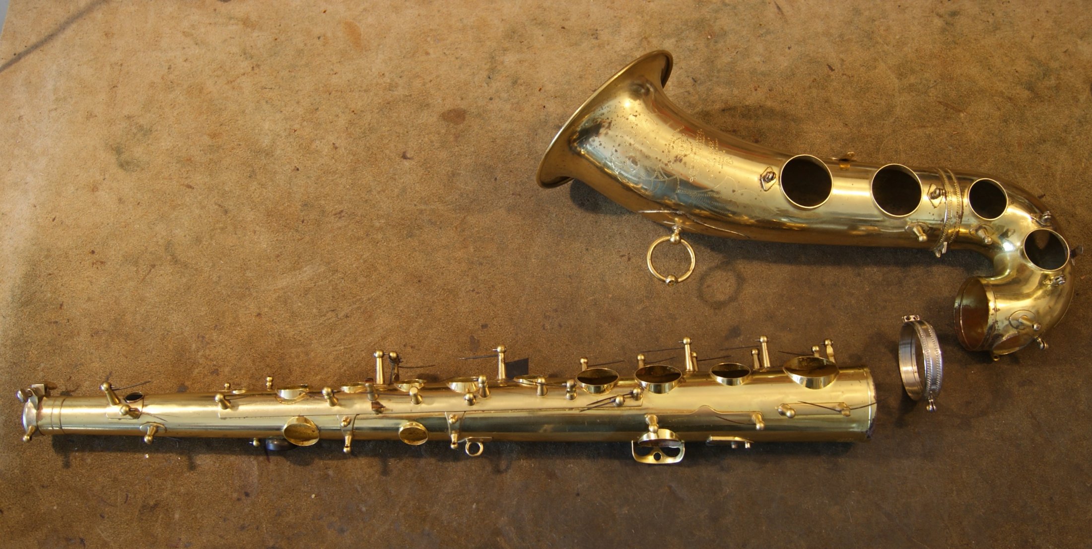 Disassembled saxophone body for cleaning, dents repair & complete springs replacement